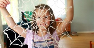 Maia holding yarn spiderweb